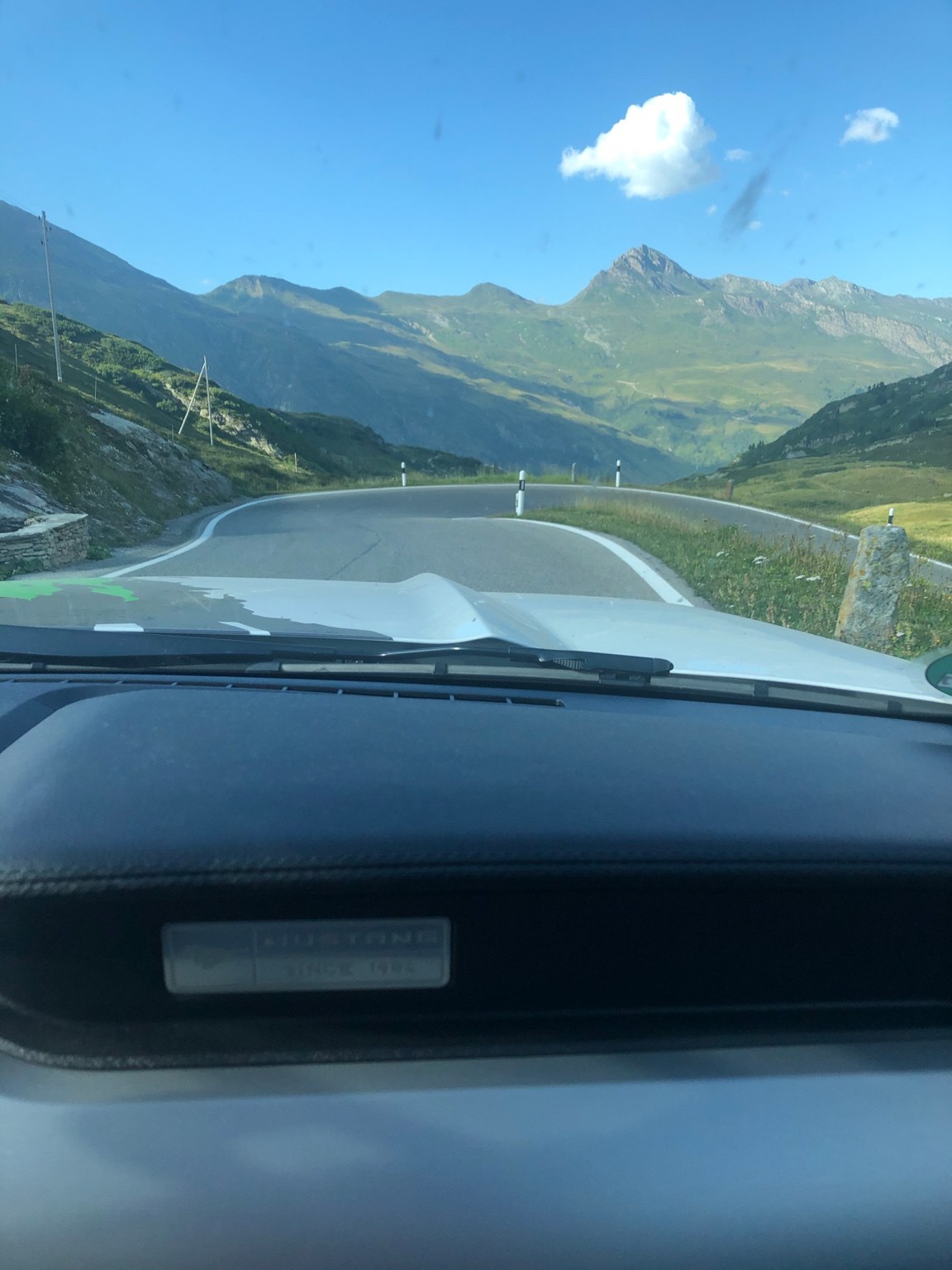 Winding Alpine road illustrating precise vehicle dynamics